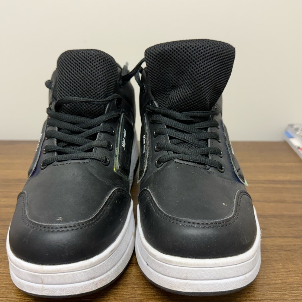 Black and white roller skates/athletic shoe.